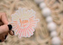 Load image into Gallery viewer, Hand holding circular vinyl sticker with 'I am' text surrounded by positive affirmations in orange and yellow