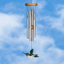Load image into Gallery viewer, Wind chime with silver tubes, wooden top, and decorative hummingbird against blue sky