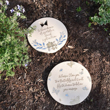 Load image into Gallery viewer, Two round memorial garden stones with butterfly designs and inspirational text on mulched soil