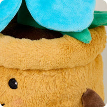 Load image into Gallery viewer, Yellow plush teddy bear wearing bright blue flower pot hat with green leaves