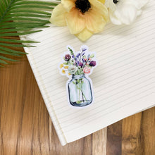 Load image into Gallery viewer, Clear vinyl sticker featuring watercolor wildflowers in glass mason jar on lined paper