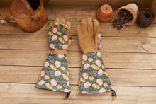 Load image into Gallery viewer, Floral patterned gardening gloves with extended arm protection on wooden surface with garden tools