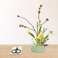 Load image into Gallery viewer, Mini ikebana kit with green ceramic bowl, scissors, and spring flower arrangement on wooden surface