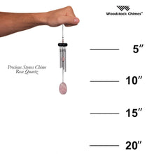 Load image into Gallery viewer, Woodstock Precious Stones wind chime with rose quartz stone and silver tubes held by hand