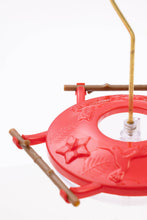 Load image into Gallery viewer, Red hummingbird feeder with wooden perches and decorative star and leaf design