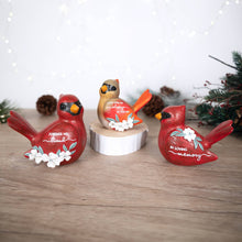 Load image into Gallery viewer, Three decorative cardinal figurines with memorial messages and white flowers on wooden surface