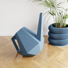 Load image into Gallery viewer, Modern geometric blue watering can with angular design and handle on wooden surface