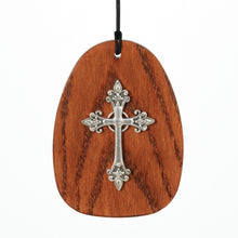 Load image into Gallery viewer, Wooden oval wind chime with decorative silver cross design on black cord