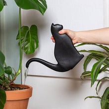 Load image into Gallery viewer, Black cat-shaped watering can being used to water houseplant in terracotta pot