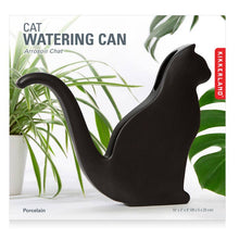 Load image into Gallery viewer, Black porcelain cat-shaped watering can with curved spout and tail handle surrounded by houseplants