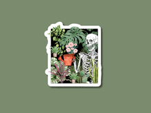 Load image into Gallery viewer, Decorative sticker featuring skeleton surrounded by houseplants with red pot reading 'You Make Me Feel Alive'