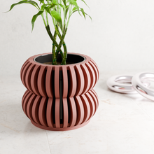 Load image into Gallery viewer, Terracotta ribbed double-tiered planter with bamboo plant on white surface