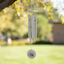 Load image into Gallery viewer, Silver wind chime with purple pansy design hanging from tree branch in garden