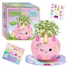 Load image into Gallery viewer, Pink unicorn-shaped planter kit with chia sprouts growing, includes decorative stickers and packaging