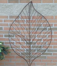 Load image into Gallery viewer, Metal wire leaf-shaped garden trellis mounted on brick wall for climbing plants