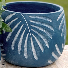 Load image into Gallery viewer, Blue ceramic planter with white tropical leaf pattern design sitting on wooden surface