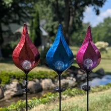 Load image into Gallery viewer, Three colorful metal garden stakes with flame-shaped glass tops in red, blue, and purple