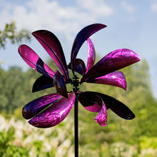 Load image into Gallery viewer, Purple metallic wind spinner with curved petal blades on pole against blue sky