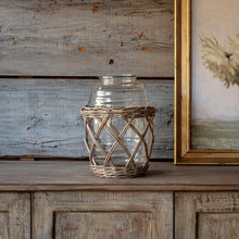 Load image into Gallery viewer, Clear glass jar with woven wicker basket holder on rustic wooden surface