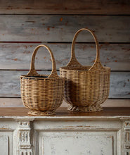 Load image into Gallery viewer, Two woven brown poly baskets with handles sitting on white vintage cabinet
