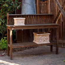 Load image into Gallery viewer, Wooden potting table with two shelves displaying decorative planters in outdoor garden setting