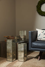 Load image into Gallery viewer, Antique-style mirrored glass lanterns with candles displayed next to blue leather chair