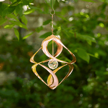 Load image into Gallery viewer, Copper garden wind spinner with crystal center hanging outdoors among green foliage