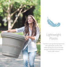 Load image into Gallery viewer, Woman easily carrying large gray lightweight plastic planter outdoors in garden setting