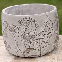 Load image into Gallery viewer, Gray concrete planter with etched botanical wildflower and grass designs on outdoor surface