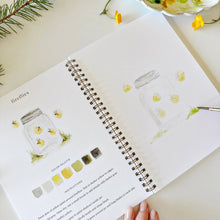 Load image into Gallery viewer, Spiral-bound camping watercolor workbook open to fireflies lesson with mason jar illustrations