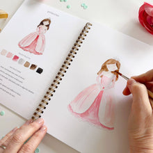 Load image into Gallery viewer, Hands painting watercolor princess in pink dress using fairytale art workbook with color palette