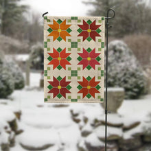 Load image into Gallery viewer, Quilted garden flag with six colorful poinsettia star patterns in red, orange, and burgundy on snowy background