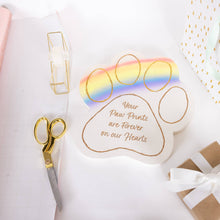Load image into Gallery viewer, White paw-shaped memorial garden stone with rainbow bridge design and golden sentiment text