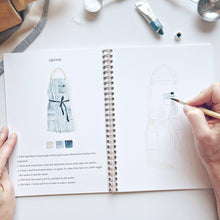 Load image into Gallery viewer, Open watercolor workbook showing apron painting tutorial with step-by-step instructions and hand holding brush