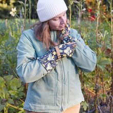 Load image into Gallery viewer, Woman wearing floral arm saver gardening gloves with extended sleeves in garden setting