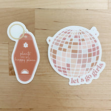 Load image into Gallery viewer, Two decorative stickers on wood surface - vintage motel keychain and disco ball with plant-themed quotes