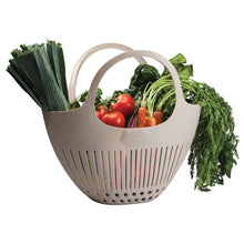Load image into Gallery viewer, Beige plastic garden colander with handles filled with fresh vegetables including tomatoes, carrots, and leafy greens