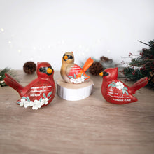Load image into Gallery viewer, Three decorative cardinal figurines with inspirational text on wooden surface with holiday greenery