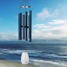 Load image into Gallery viewer, Wind chime with dark blue tubes and white sail against ocean beach backdrop