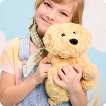 Load image into Gallery viewer, Young girl smiling while hugging a golden plush dog toy teddy bear