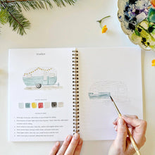 Load image into Gallery viewer, Spiral-bound camping watercolor workbook open to vintage trailer painting tutorial page