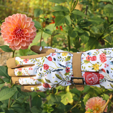 Load image into Gallery viewer, Floral patterned gardening gloves with leather palms displayed among blooming dahlia flowers