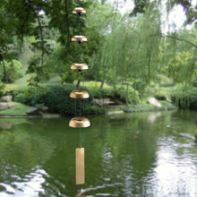 Load image into Gallery viewer, Brass wind chime with five graduated bells hanging over peaceful garden pond