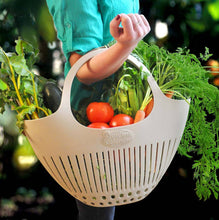 Load image into Gallery viewer, Person carrying white plastic garden colander filled with fresh vegetables and leafy greens