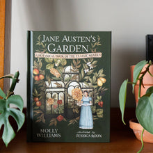 Load image into Gallery viewer, Jane Austen's Garden hardcover book with botanical illustrations displayed between potted plants