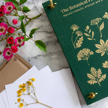 Load image into Gallery viewer, Green linen botanical flower press with gold foil plant designs and pressed yellow flowers