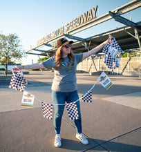 Load image into Gallery viewer, Woman holding checkered flag bunting with Welcome Race Fans text at Indianapolis Motor Speedway entrance