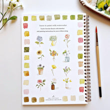 Load image into Gallery viewer, Spiral-bound watercolor workbook featuring twelve flower painting tutorials with color swatches and brush