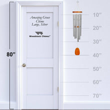 Load image into Gallery viewer, Amazing Grace wind chime with silver tubes and wooden striker shown next to door for size reference