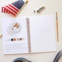 Load image into Gallery viewer, Open watercolor workbook showing apple pie painting tutorial with American flag and art supplies